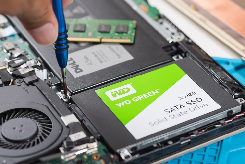 Technician testing the battery health of a refurbished laptop