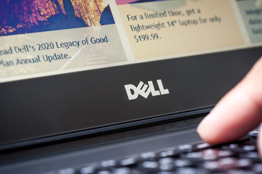 Refurbished Dell laptop on desk with accessories