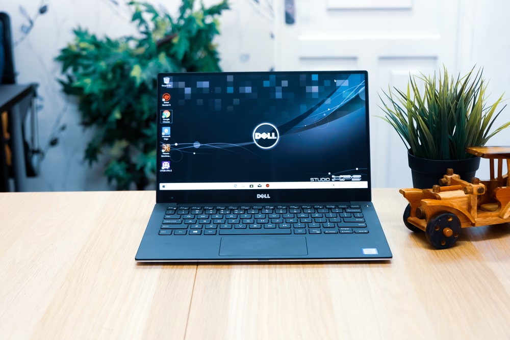 Refurbished Dell laptop on desk with accessories