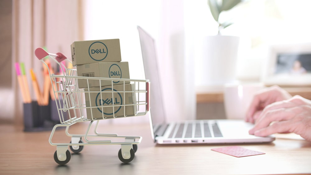 Refurbished Dell laptop on desk with accessories