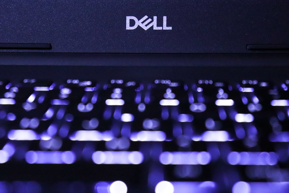 Refurbished Dell laptop on desk with accessories